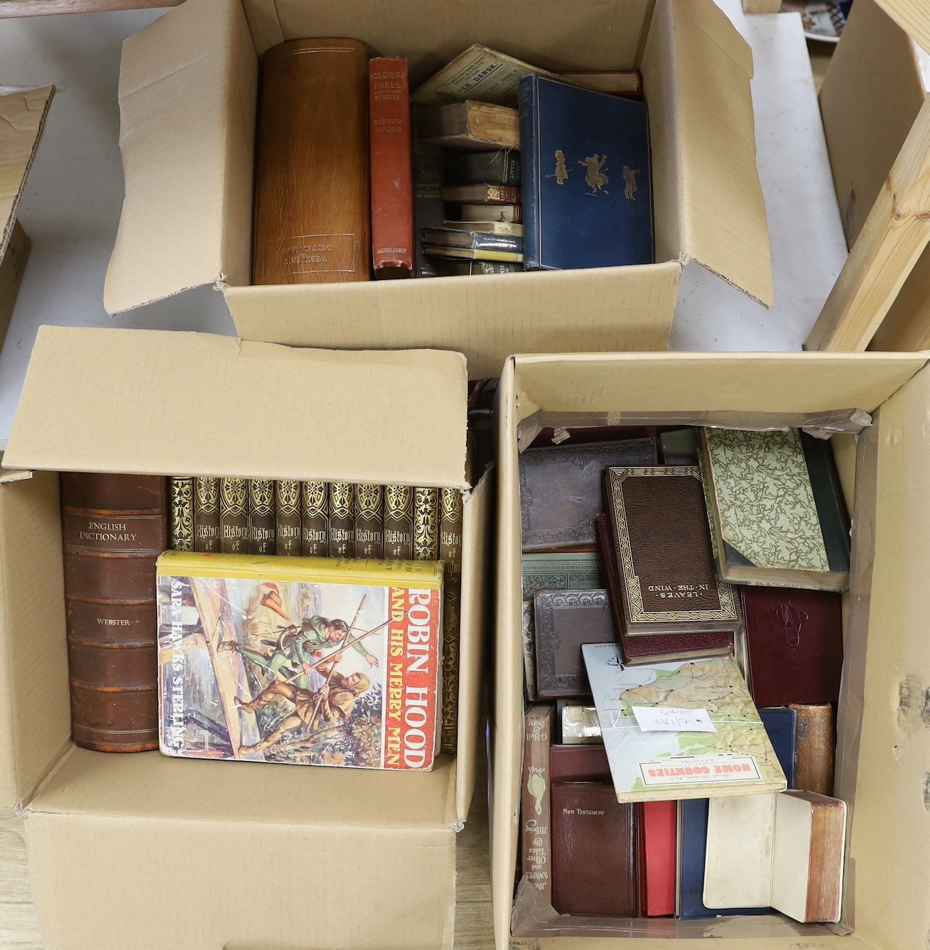 A quantity of assorted books to include Websters dictionaries.